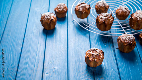 Muffins. Baking with coconut shavings on a blue background.Copy space for Text.selective focus.