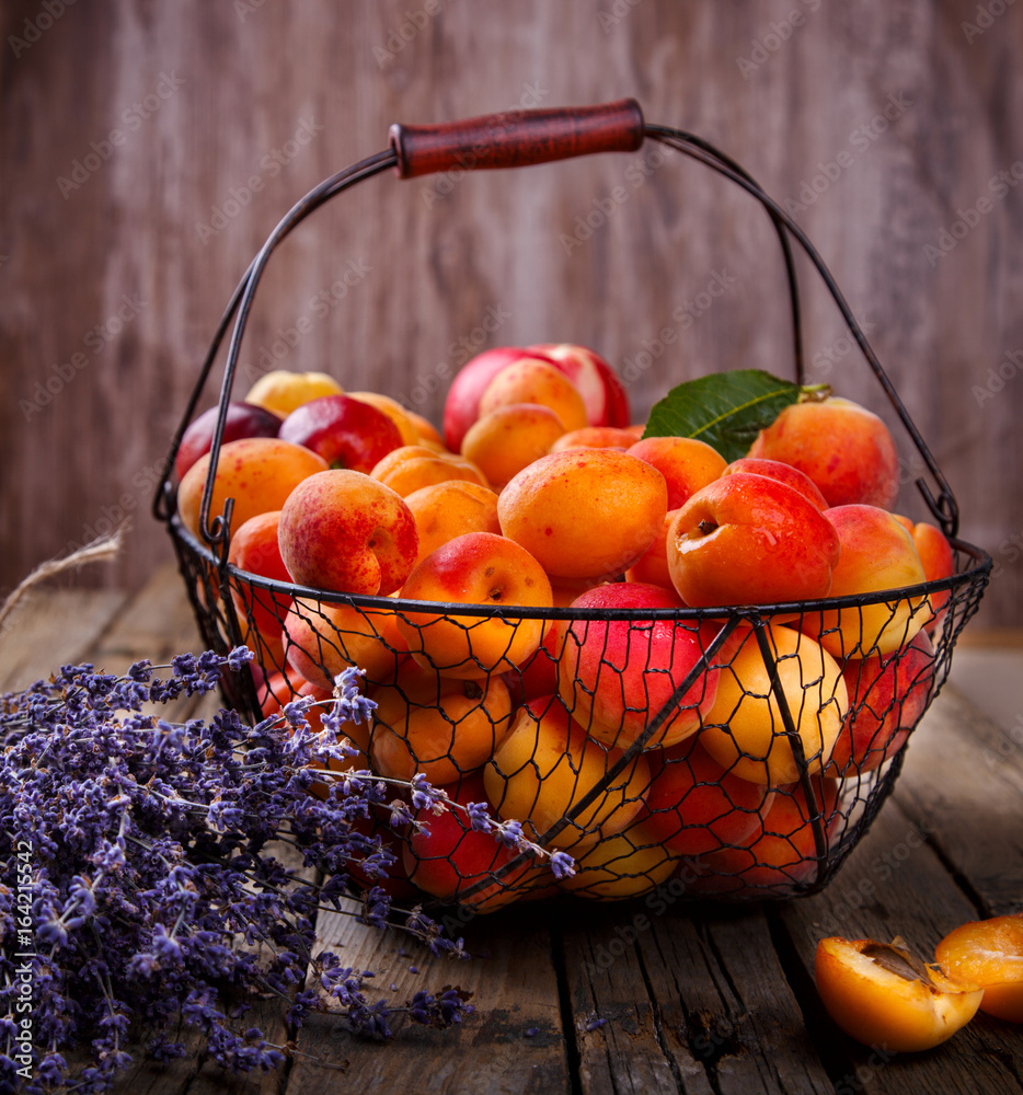 Apricots, Fruits in a metal basket on a vintage wooden background.Lavender,  Flowers Bouquet.Food or Healthy diet concept.Super Food.Vegetarian.Copy  space for Text.selective focus. Stock Photo | Adobe Stock