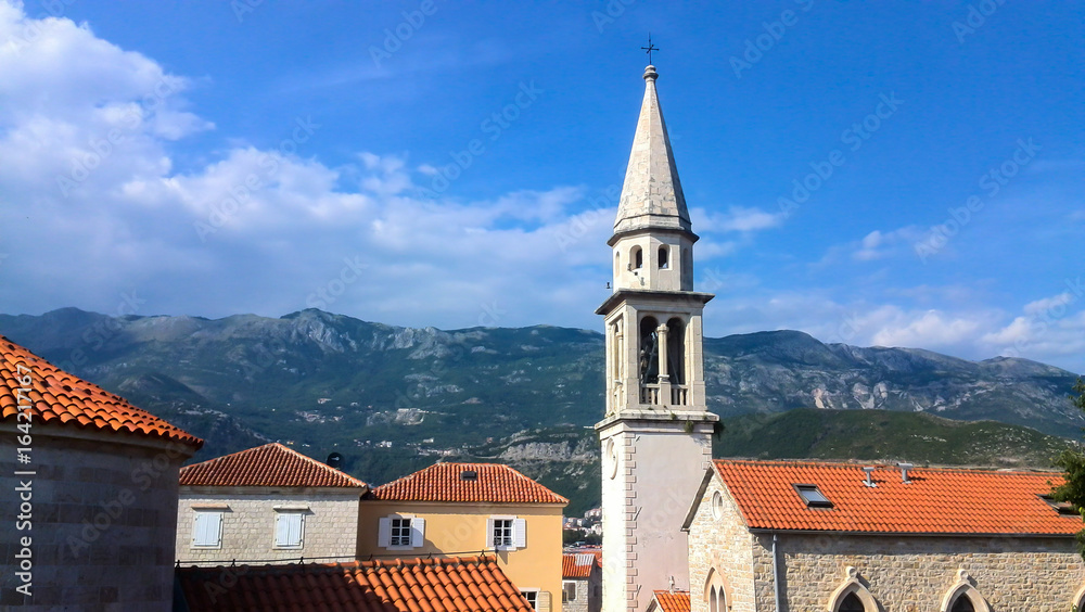 Famous chapel of the fortress and orange roofs in old city of Budva, Montenegro