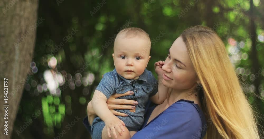 Beautiful young mother holding adorable cute child smiling outdoor nature summer walk son infant toddler parent motherhood little boy native smile mom woman happy kid childhood hug hugging hugs baby Beautiful young mother holding adorable cute child smiling outdoor nature summer walk son infant toddler parent motherhood little boy native smile mom woman happy kid childhood hug hugging hugs baby