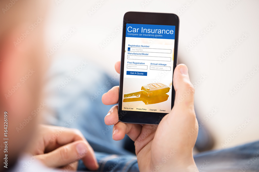 Man Filling Car Insurance Form On Mobile Phone Man Filling Car Insurance Form On Mobile Phone