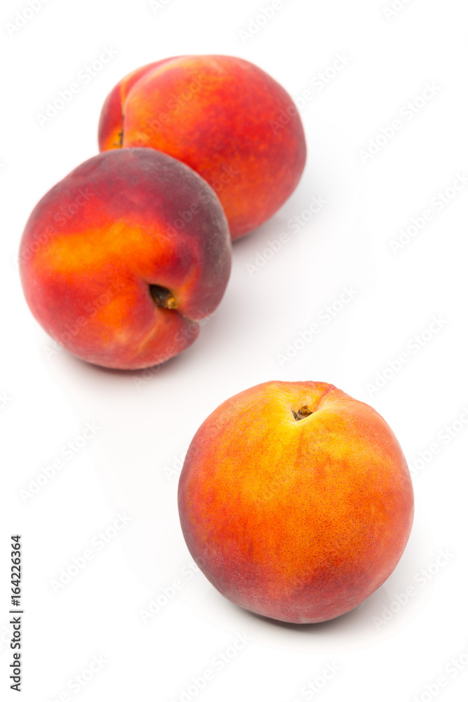 Three uncut, whole, ripe peaches fruit