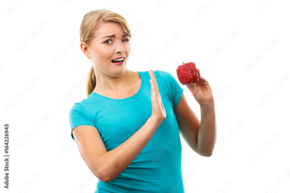 Disgusted woman holding old wrinkled peppers, unhealthy eating Disgusted woman holding old wrinkled peppers, unhealthy eating