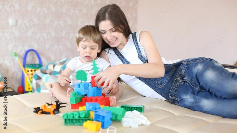 mother and young son played in the nursery toys mother and young son played in the nursery toys