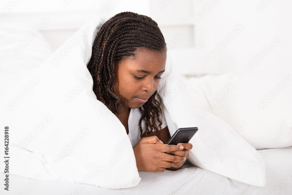 Girl In Bed Using Cell Phone Girl In Bed Using Cell Phone