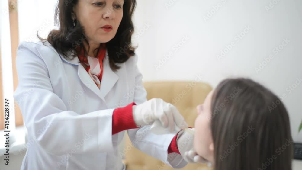 Doctor checking or examining throat swab test young female patient Doctor checking or examining throat swab test young female patient