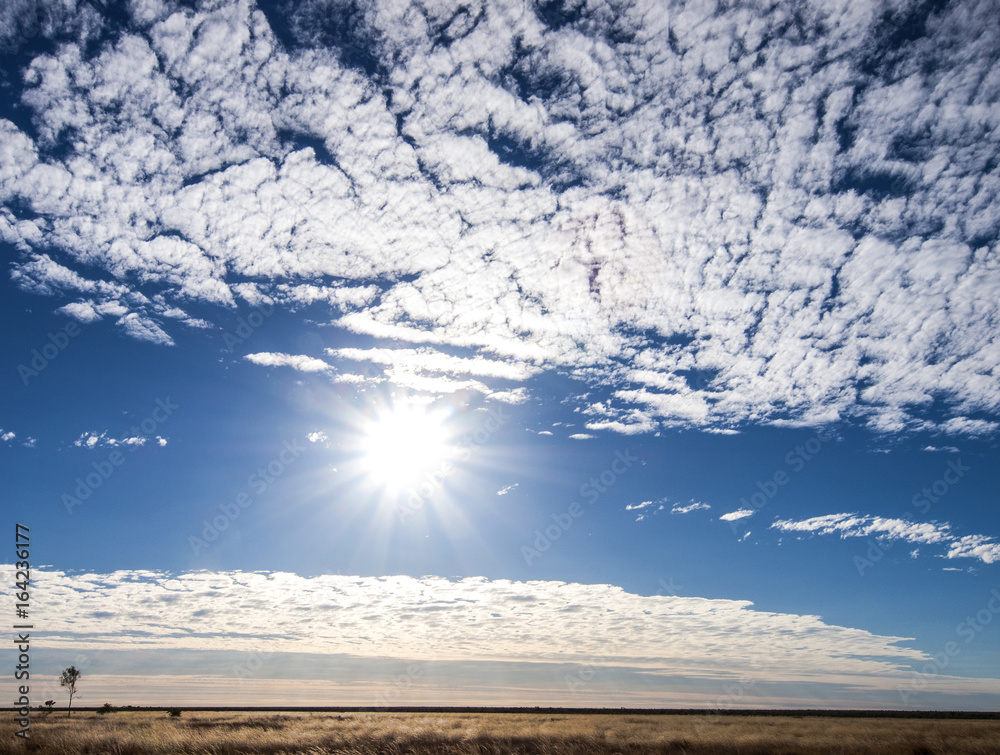 A scorching midday sun bakes the open grasslands of central Queensland, Australia A scorching midday sun bakes the open grasslands of central Queensland, Australia