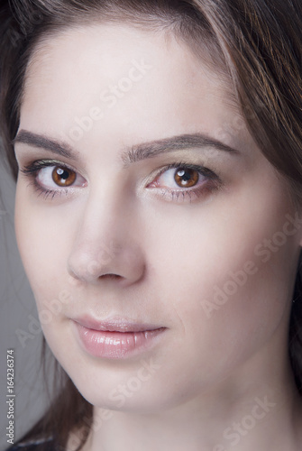 Portrait of a brunette with clean skin. Close-up.