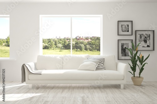 White room with sofa and summer landscape in window. Scandinavian interior design. 3D illustration