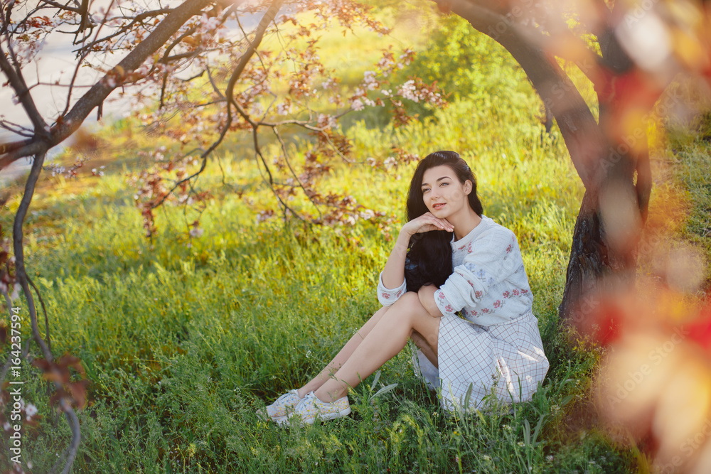 Obraz premium Woman in park. Pleasure of spring nature.