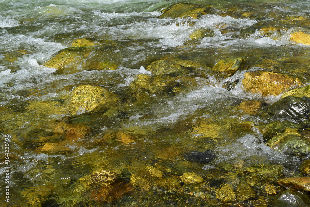 Stream of Big Ilgumen river flows between stones in Altai mountains, Siberia.