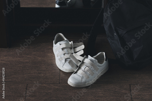 Bild auf Leinwand Pair of white shoes on velcro with backpack