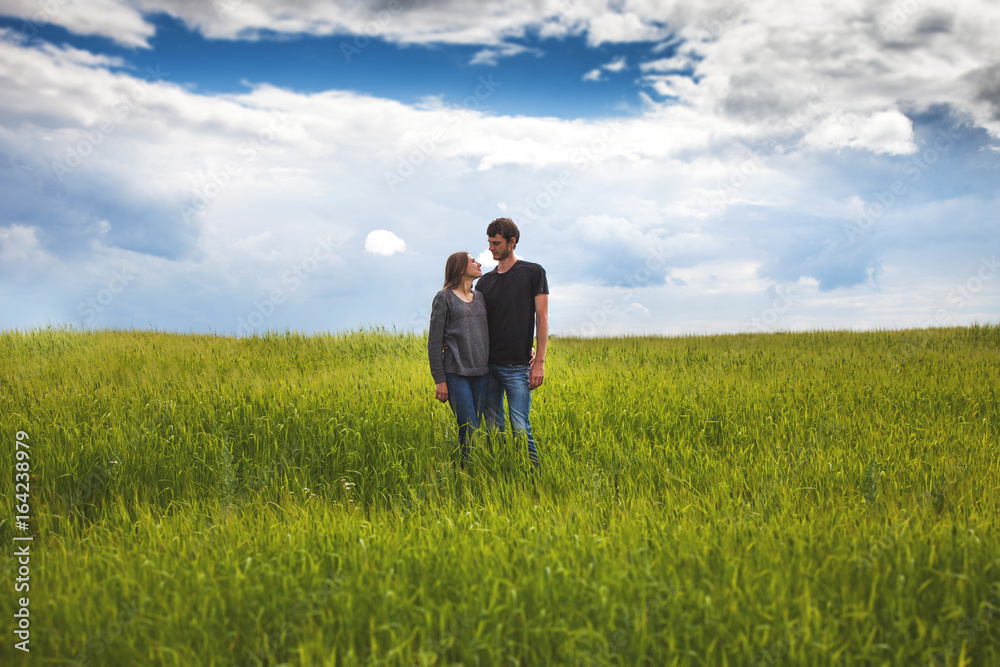 Young couple walking through green field Young couple walking through green field