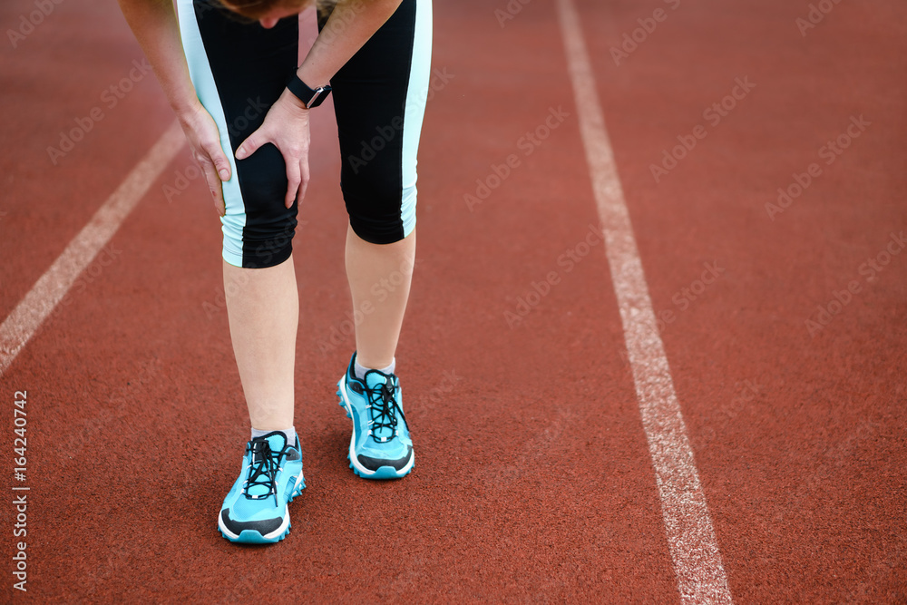 Injuries - sports running knee injury on woman.