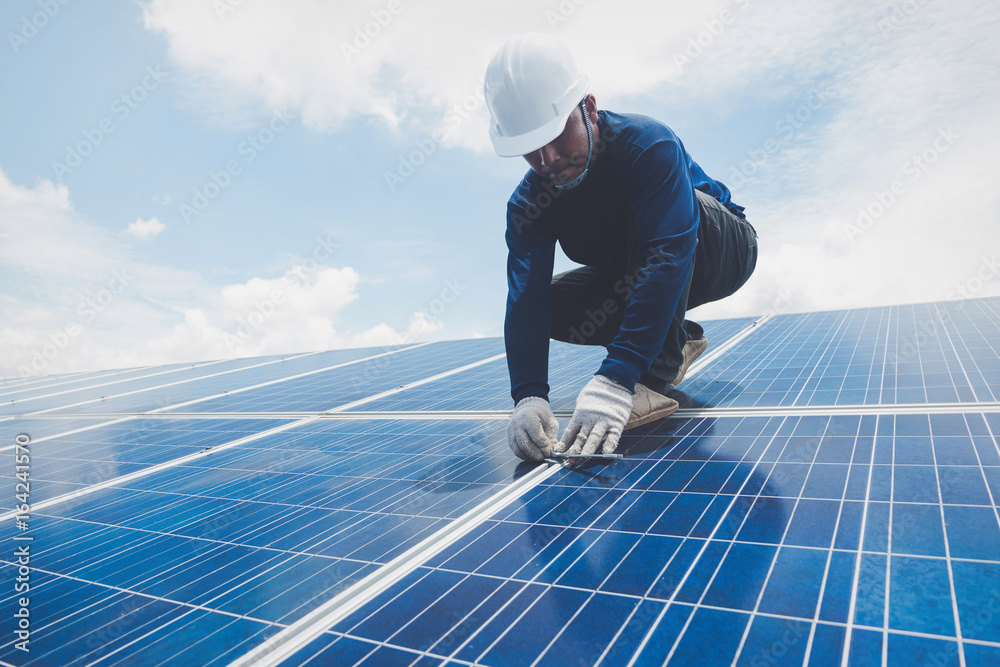 custom made wallpaper toronto digitalengineer or electrician working on replacement solar panel at solar power plant; working on repair solar panel to swap panel