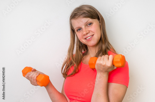 Fitness woman doing exercises with dumbbells