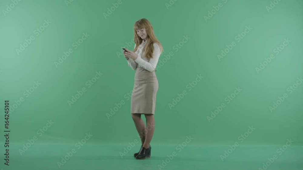 a nice girl is standing with the phone a nice girl is standing with the phone