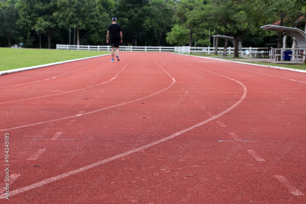 Close-up curve of a running track. Athletics track with its lane, white line and turn. Athletics lane around of football field. Close-up curve of a running track. Athletics track with its lane, white line and turn. Athletics lane around of football field.
