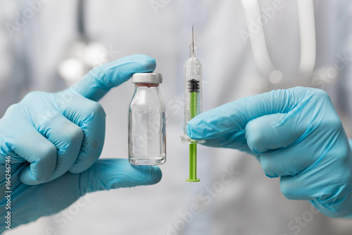 Syringe, medical injection in hand. Vaccination equipment.