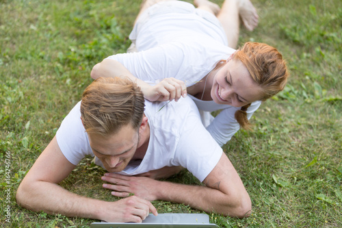 Young couple relaxing using computer laptop in park © cineberg