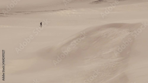 Man walking alone in desert. Great Sand Dunes National Park, Colorado, USA