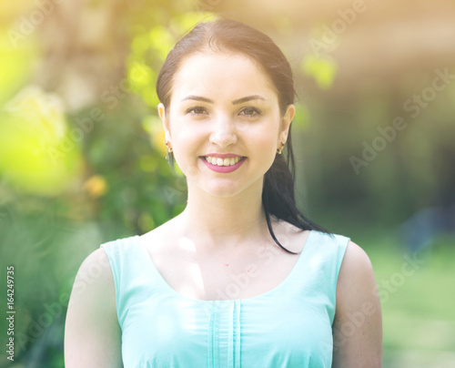 cheerful smiling young woman portrait in outdoors
