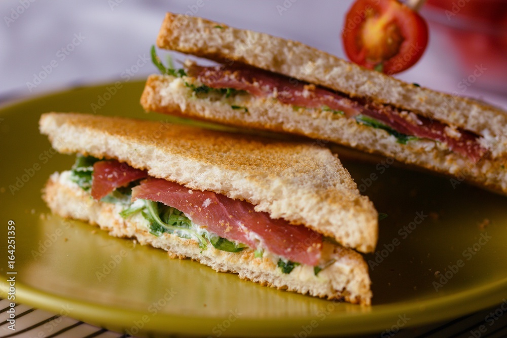 Sandwich with cheese and basil spread and carpaccio Sandwich with cheese and basil spread and carpaccio