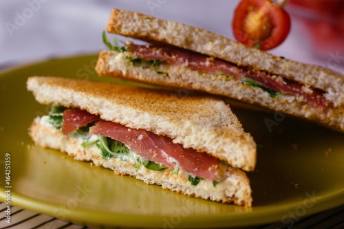 Sandwich with cheese and basil spread and carpaccio