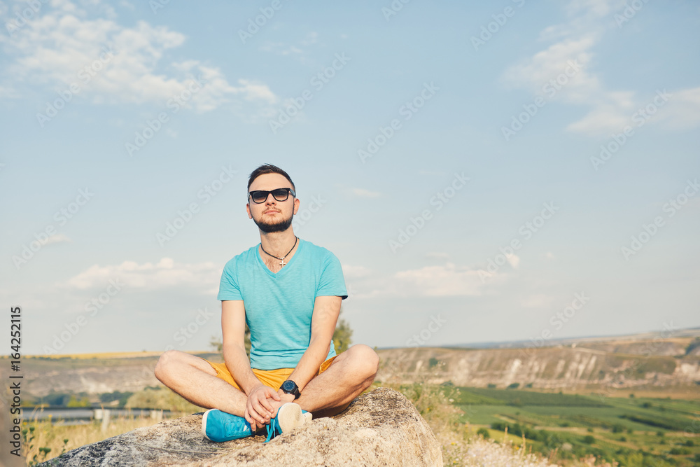 Young man smiling and enjoying sunny summer day