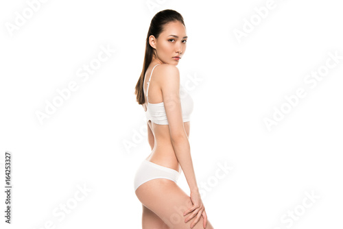 slim beautiful asian woman posing in white underwear, isolated on white