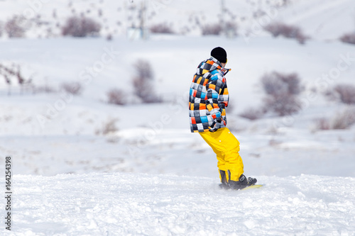 Snowboarder snowboarding in the snow in winter