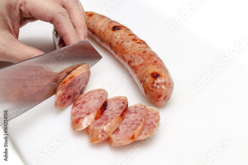 Obraz na płótnie Chef slice chinese sausage into small pieces w salonie