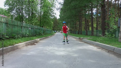 Wallpaper Mural Young boy roller skating on the road in suburbs in summer day. His younger brother is riding him on a bicycle. Torontodigital.ca