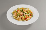 Plate with a portion of Sardinian gnocchi with shrimps and zucchini