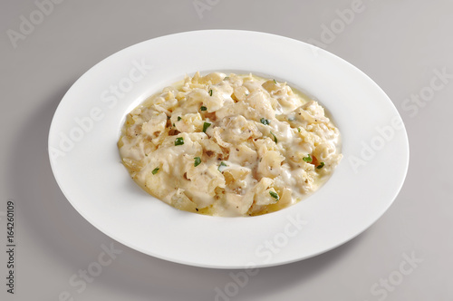 Round dish with a portion of Venetian cod