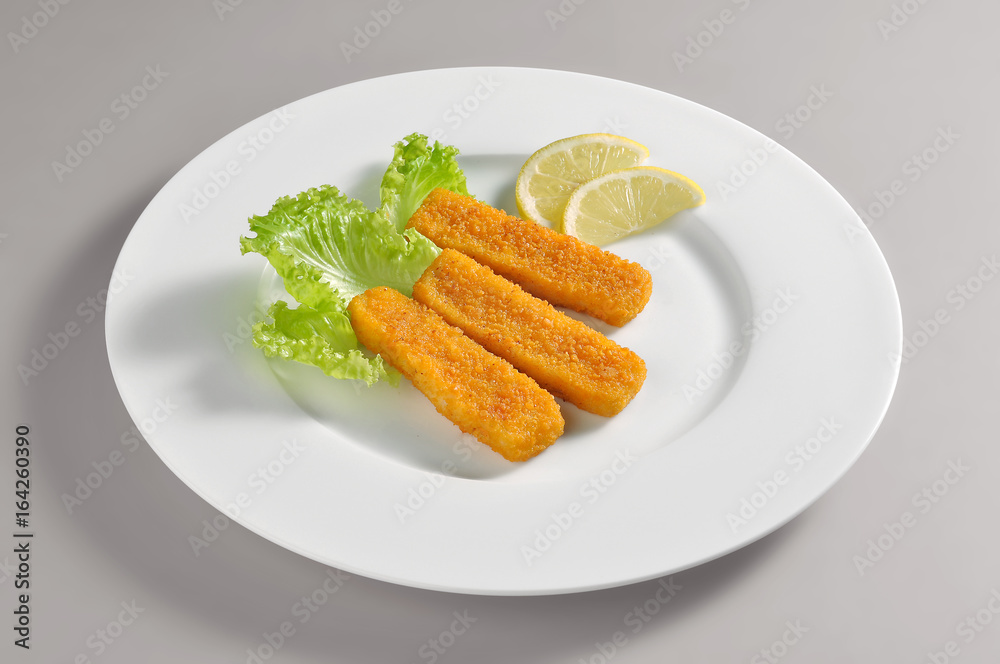 Round dish with fillet fish sticks breaded and fried Round dish with fillet fish sticks breaded and fried