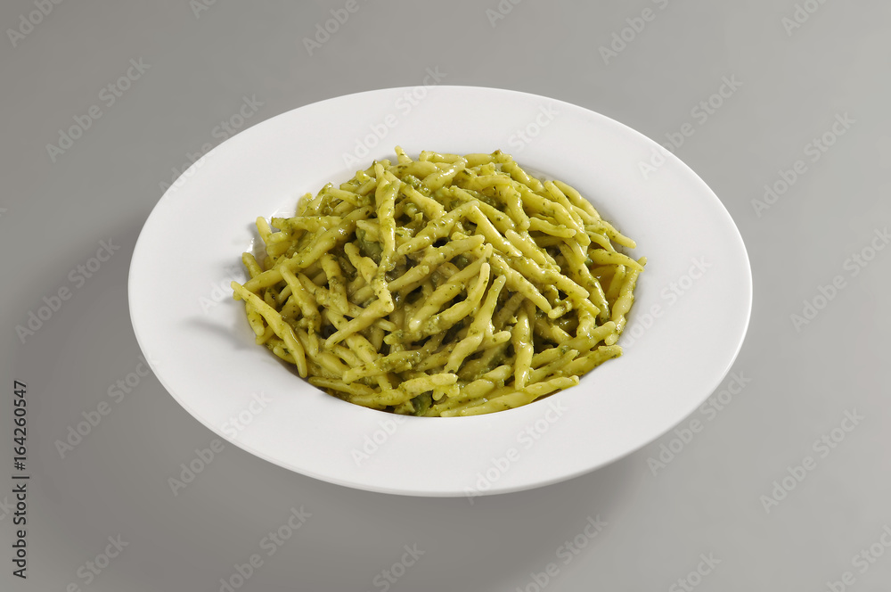 Round dish with trofie pasta with Pesto genoese