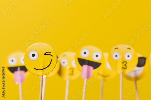 Emoji smiley social media characters on a yellow background