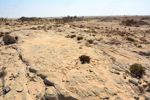Rocky deserted landscape at Jebel Jassassiyeh site in Northern Qatar.