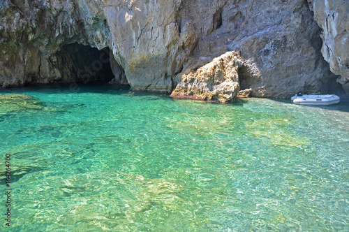 Entrance to the Green grotto with colourful walls and emerald water
