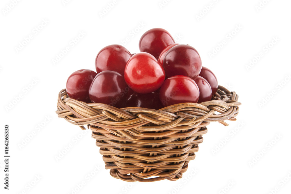 Cherries in a wicker basket isolated on a white background Cherries in a wicker basket isolated on a white background