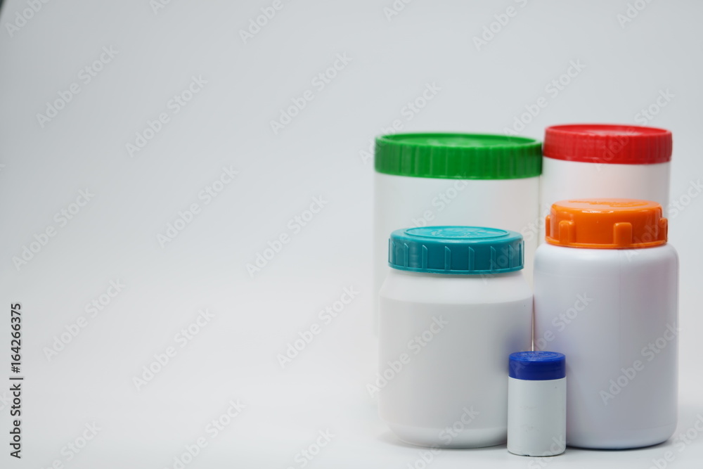 White plastic bottle with cap on white background