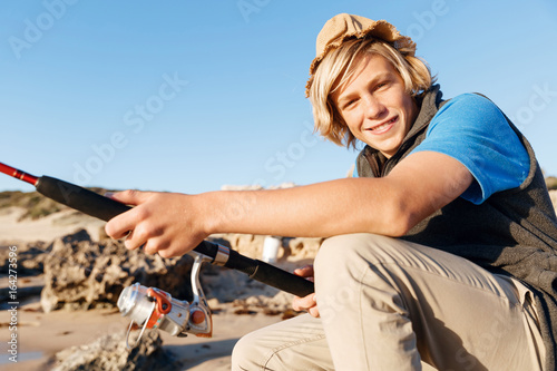 Teenage boy fishing at sea