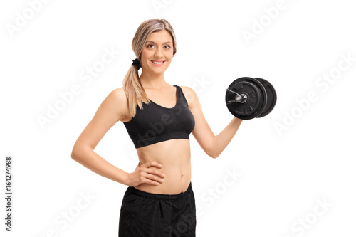 Attractive young woman with a dumbbell