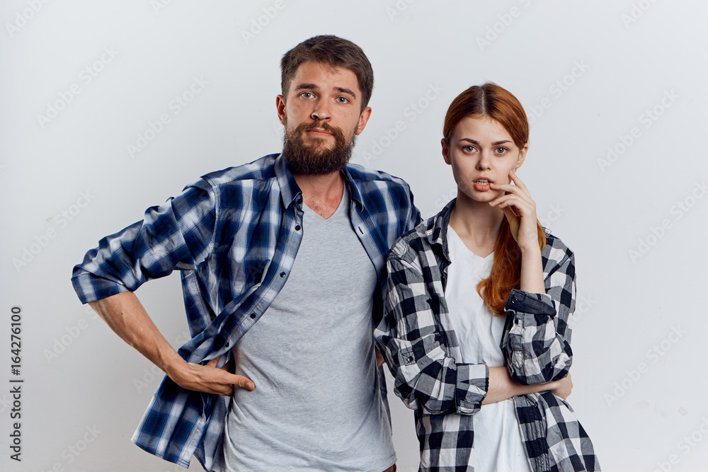 Young beautiful woman and guy with beard on white isolated background, repair, building materials, tools Young beautiful woman and guy with beard on white isolated background, repair, building materials, tools