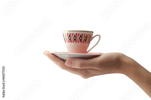 A female hand holds a cup and a saucer in the palm of your hand