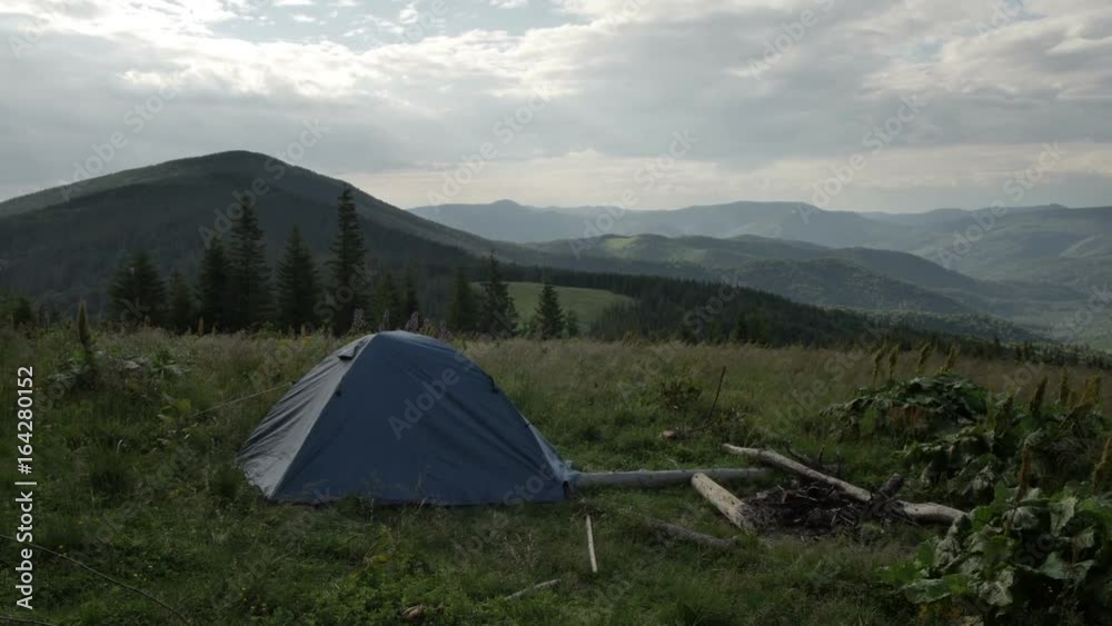 touristic tent in mountains, wind shakes the grass touristic tent in mountains, wind shakes the grass