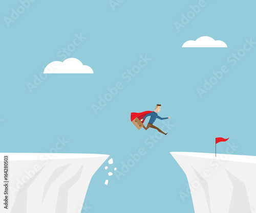 businessman jumping to red flag at cliff