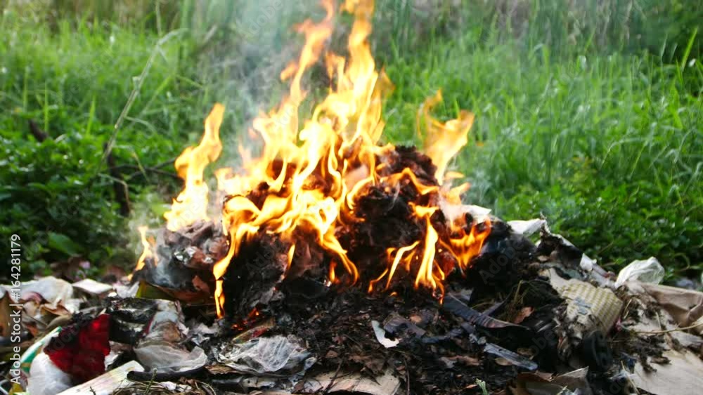 Close up to the burning fire burning garbage pile. Close up to the burning fire burning garbage pile.