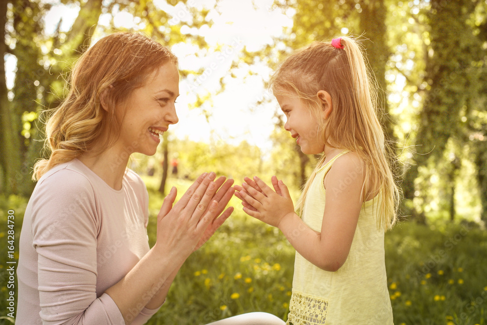 Happy mother with her little daughter in the meadow. Happy mother with her little daughter in the meadow.